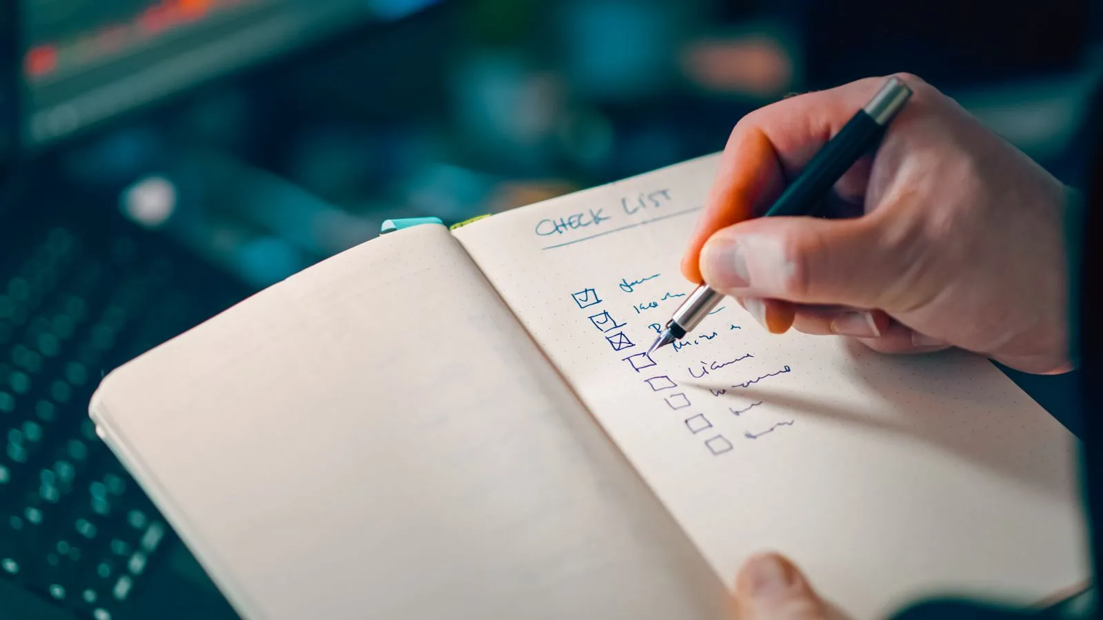 Hand ticking checkboxes on a checklist notebook — your backlink action plan, step by step