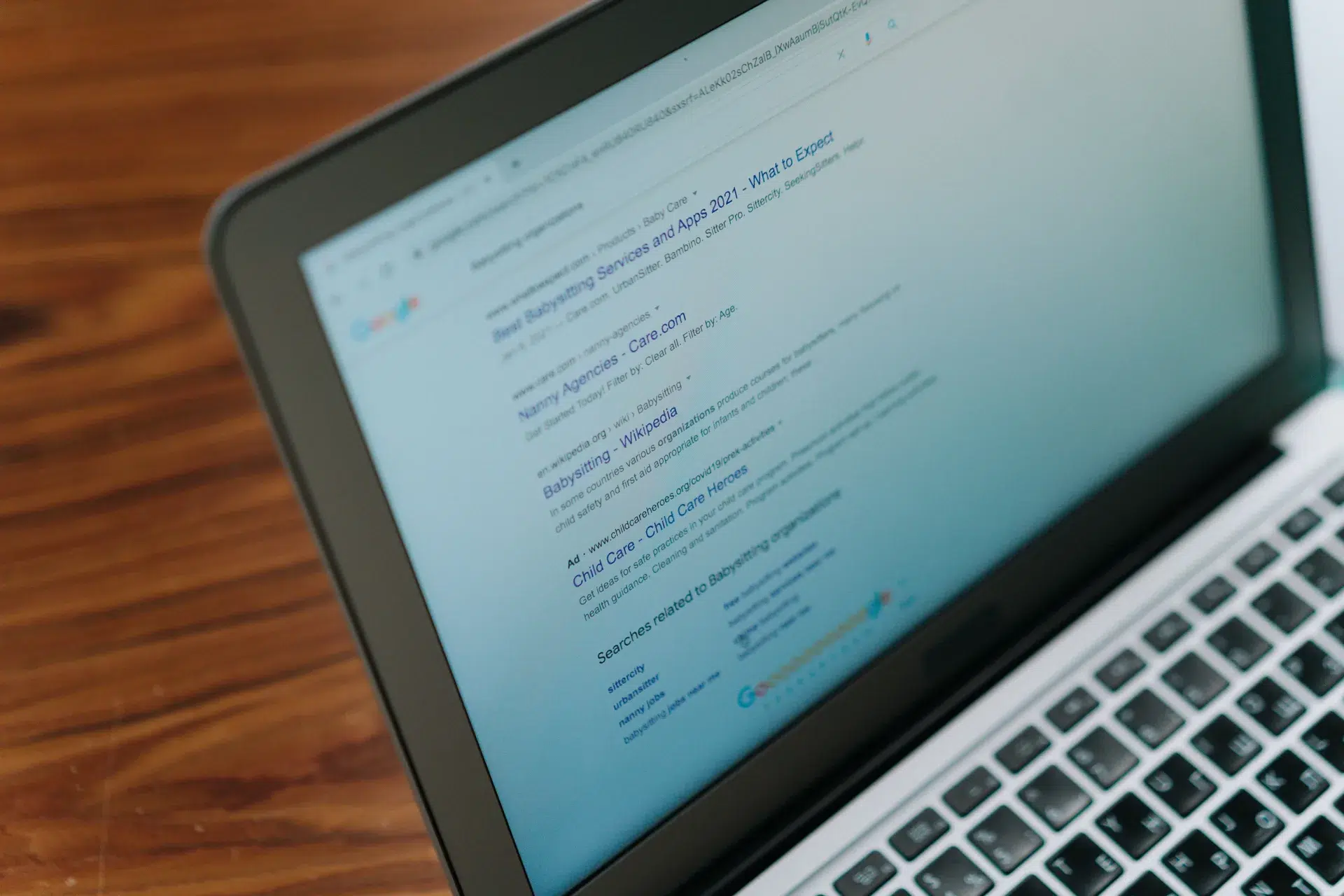 Laptop displaying a Google search results page — backlinks help pages rank higher in search